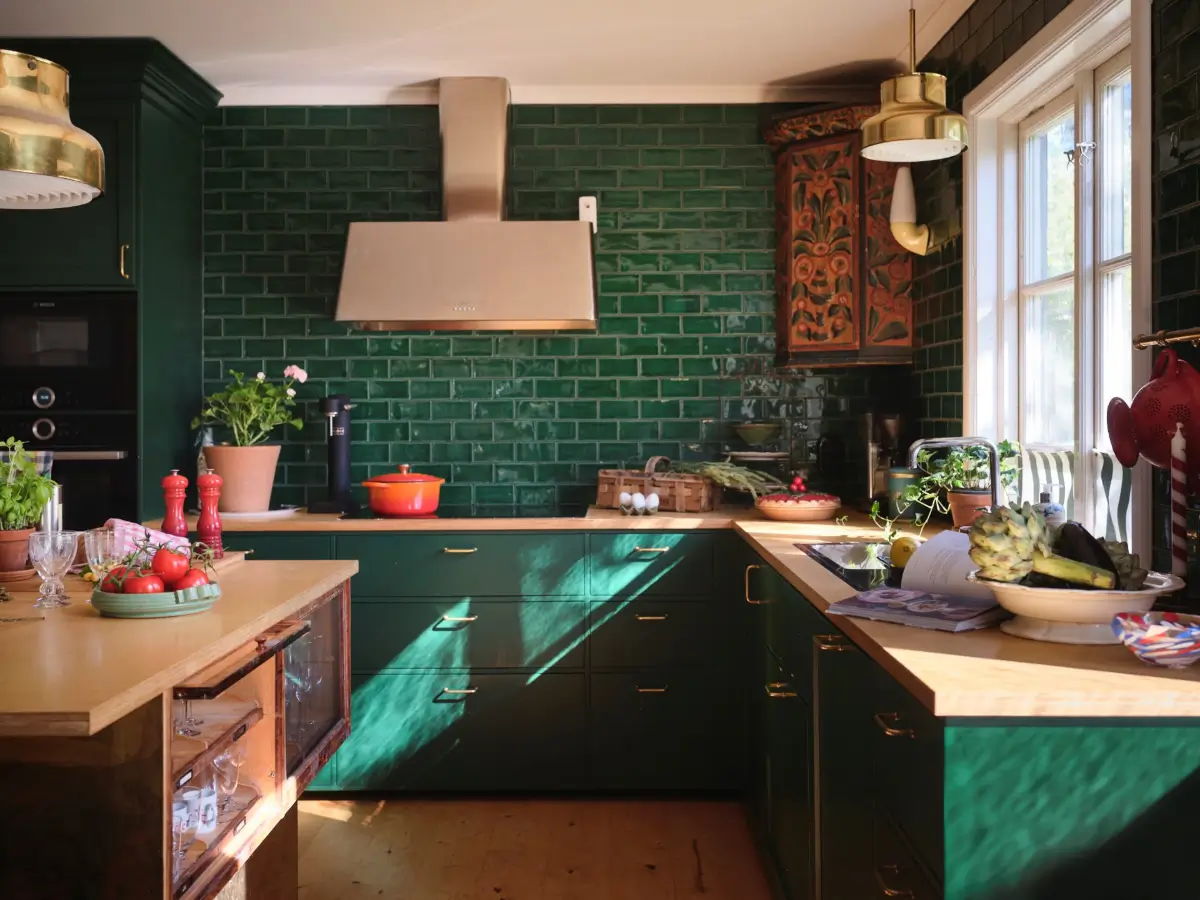 A Colorful Family Home in an Old Gardener's Cottage in Sweden 2 green kitchen cabinets and backsplash tiles