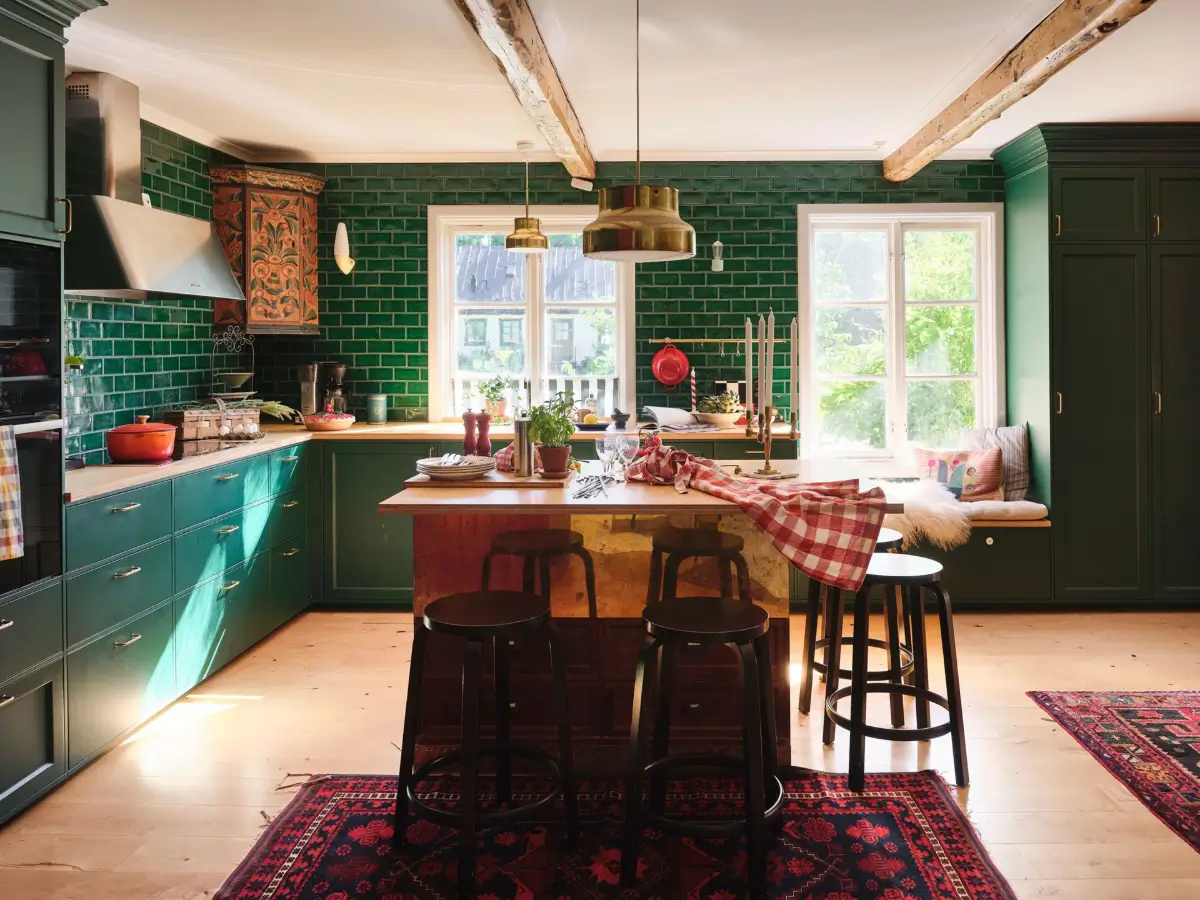green kitchen with brass island