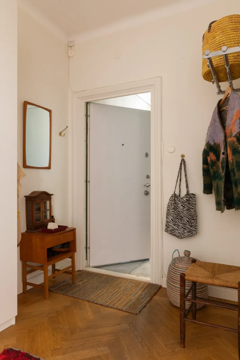 A Cozy 1920s Apartment Filled with Books, Art, and Music 23 hall herringbone floor A Cozy 1920s Apartment Filled with Books, Art, and Music