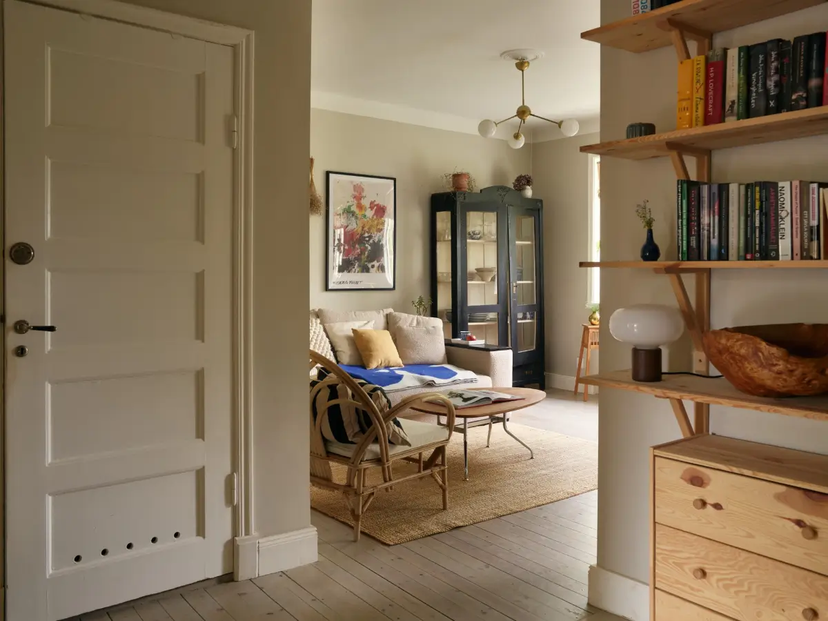 A Muted Color Palette in a Cozy 1920s Apartment in Stockholm 11 hall open doorway to living room nordroom