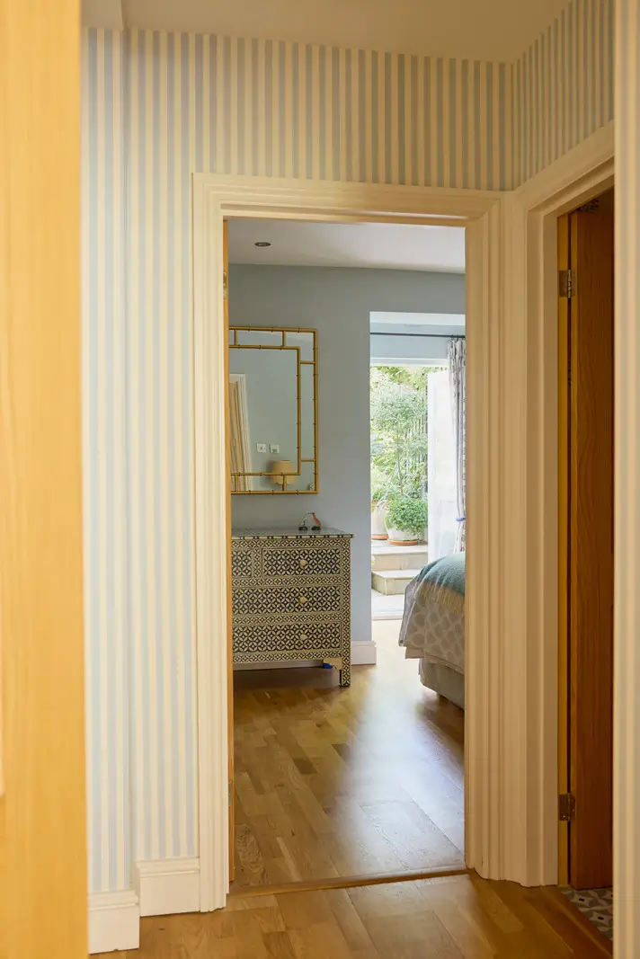 Pastel Hues in a Two-Bedroom Garden Apartment in West Kensington 8 hall pastel blue striped wallpaper
