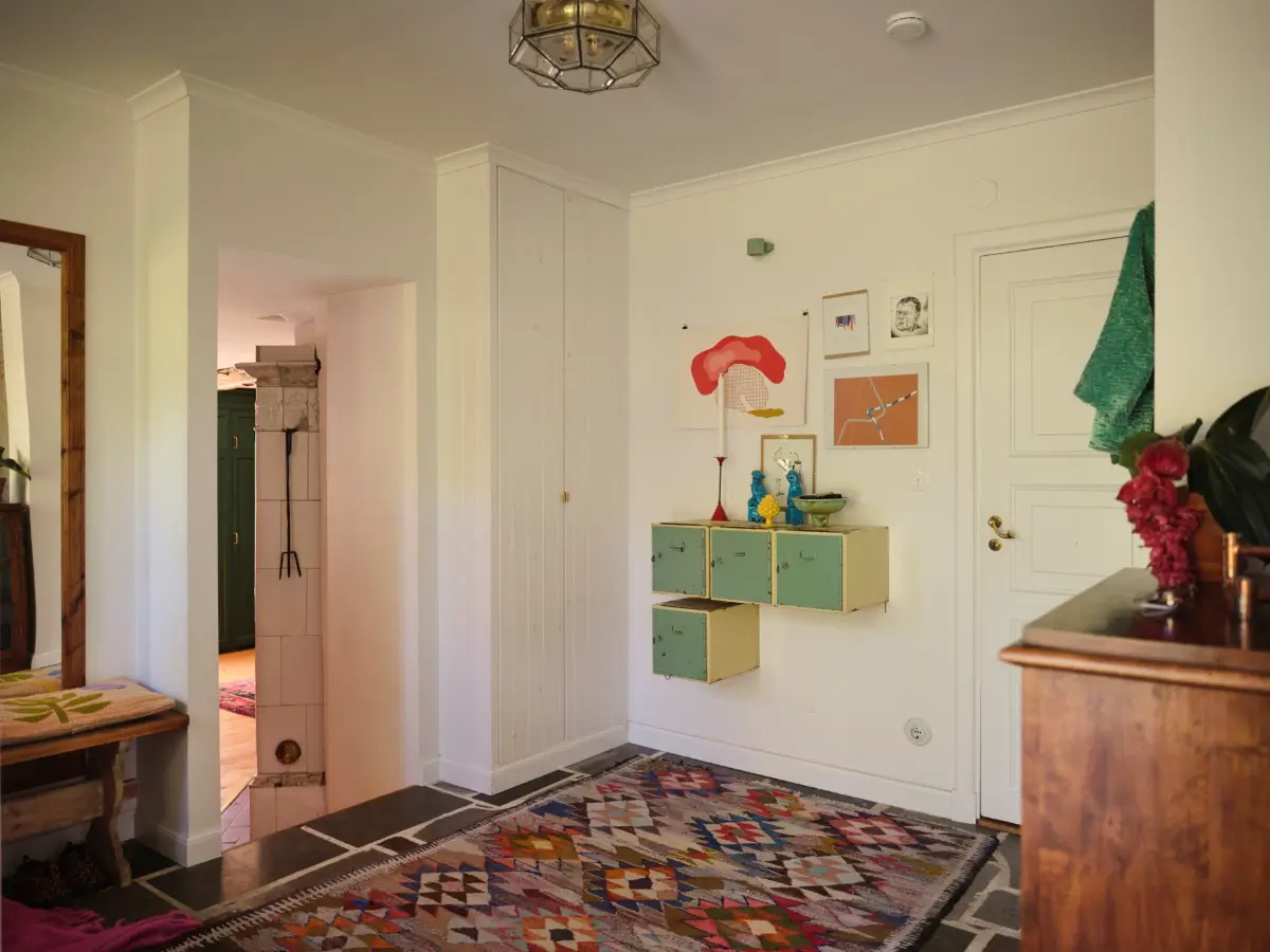 A Colorful Family Home in an Old Gardener's Cottage in Sweden 17 hall stone floor colorful rug