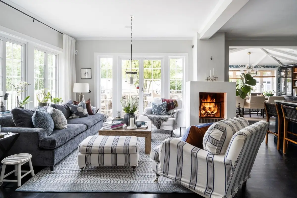 Scandinavian Design Meets The Hamptons in a Swedish Country House 9 hampton-style living room striped armchair fireplace nordroom