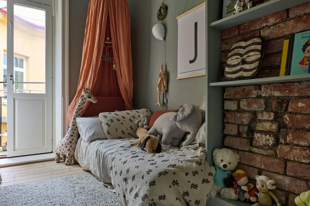 A Classic Stockholm Family Apartment with a Separate Studio 26 kids bedroom with canopy and brick wall