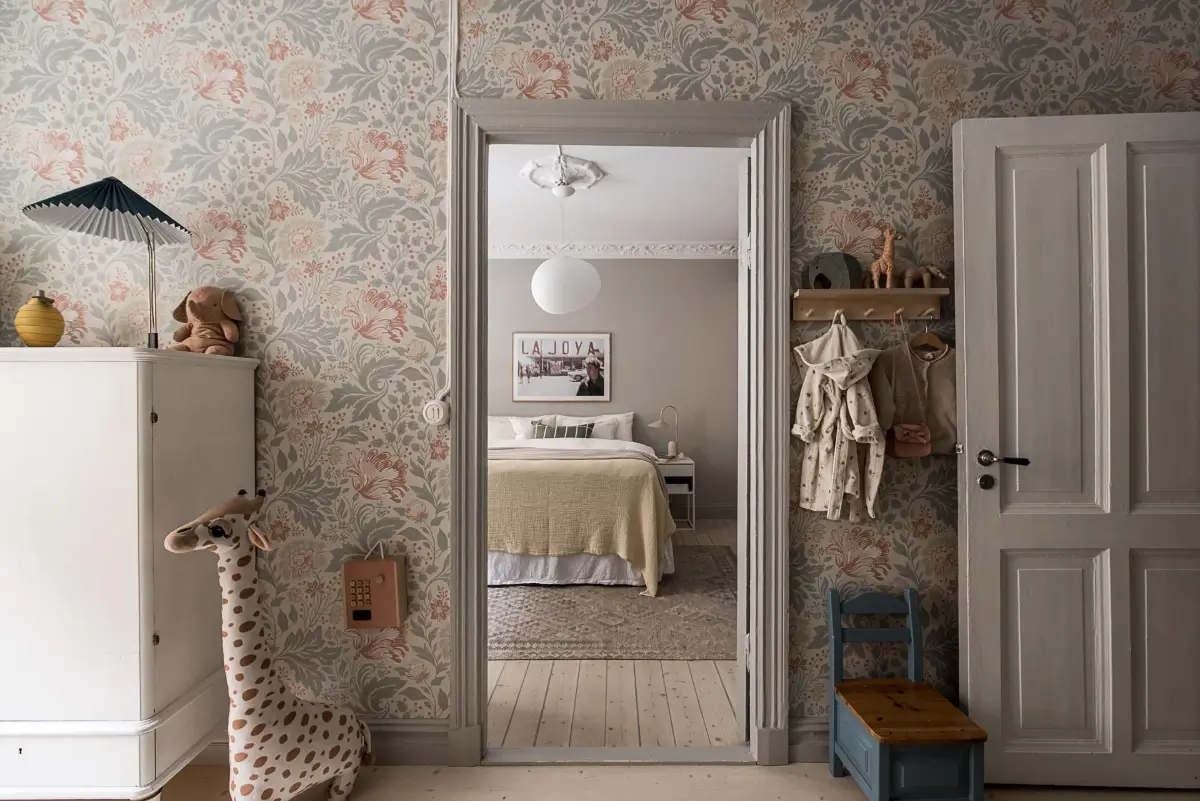 Classic Period Elements in a Comfortable Two-Bedroom Apartment 18 kids room floral wallpaper view into master bedroom