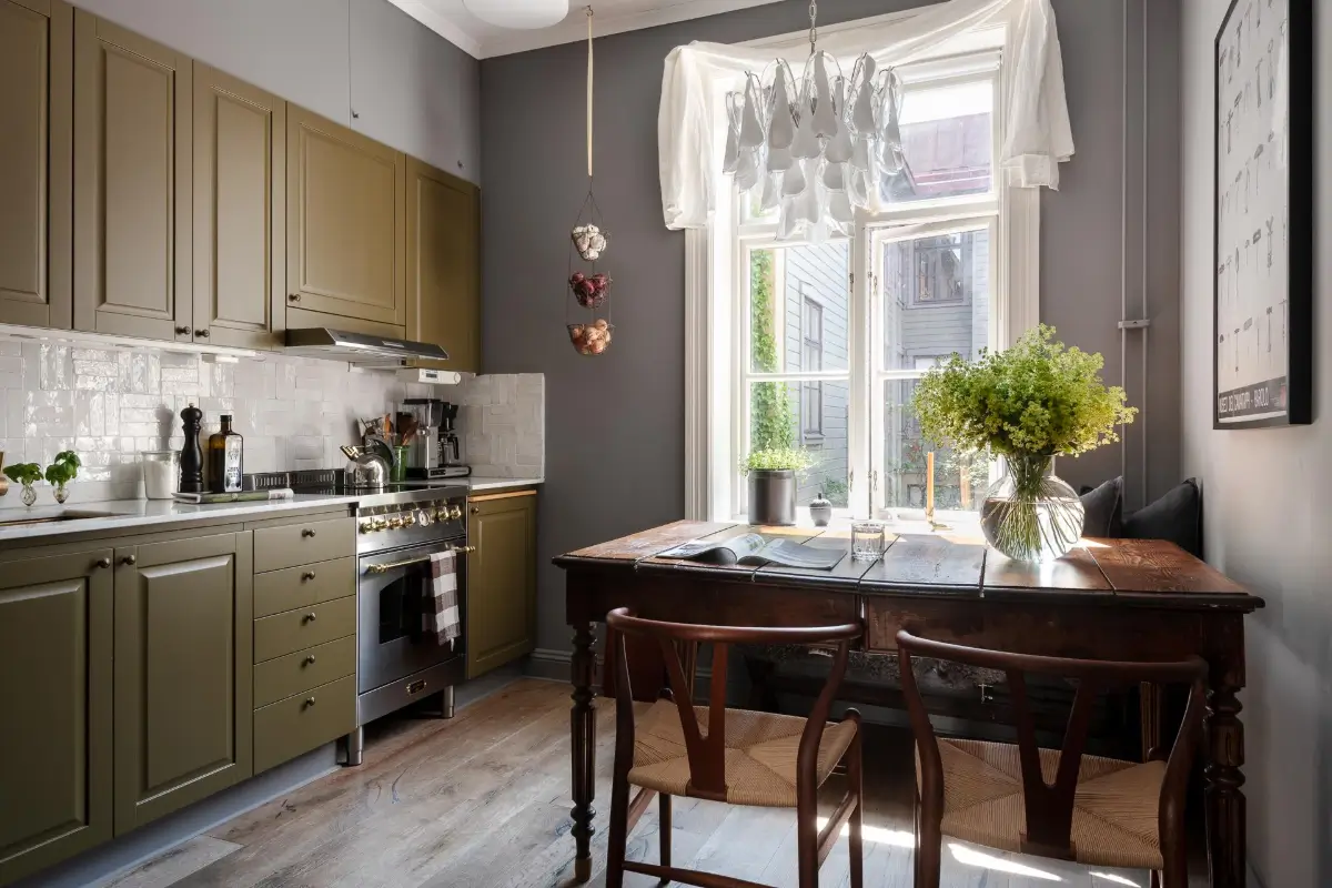 A Dark Gray Swedish Apartment with an Olive Green Kitchen 1 kitchen antique table gray walls olive green cabinets nordroom