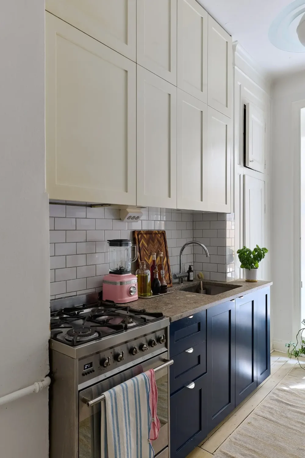 A Colorful Stockholm Apartment with a Large Terrace 10 kitchen blue and cream-colored cabinets