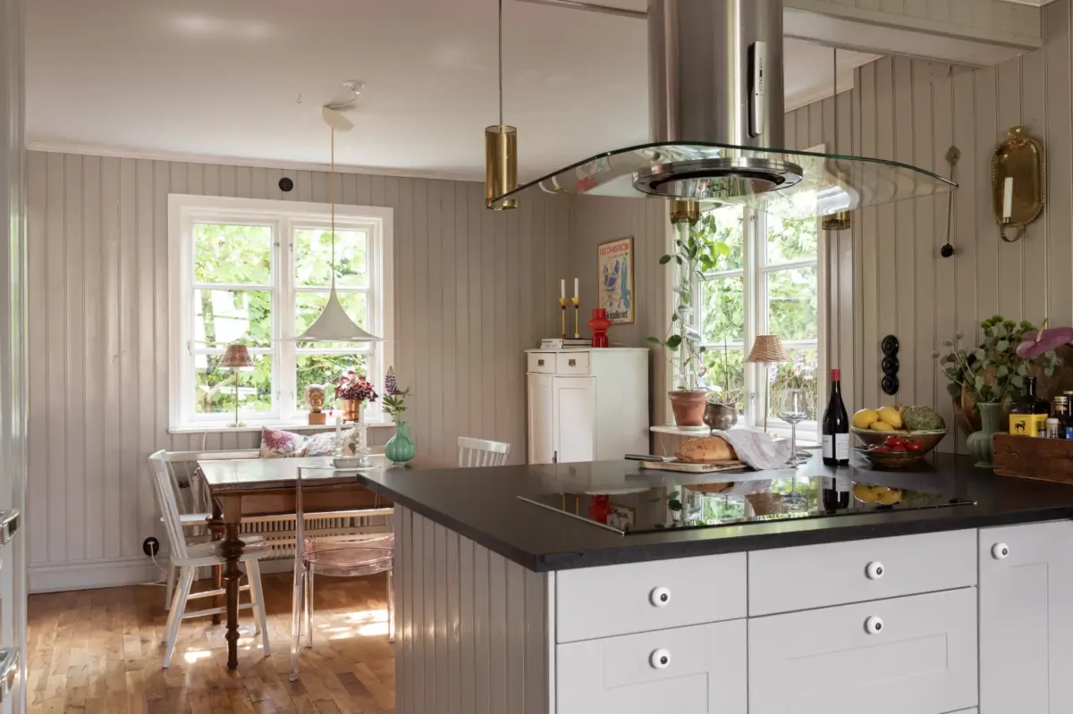 A Renovated 1920s Villa with a Spectacular Garden 7 kitchen breakfast table tongue and groove paneling