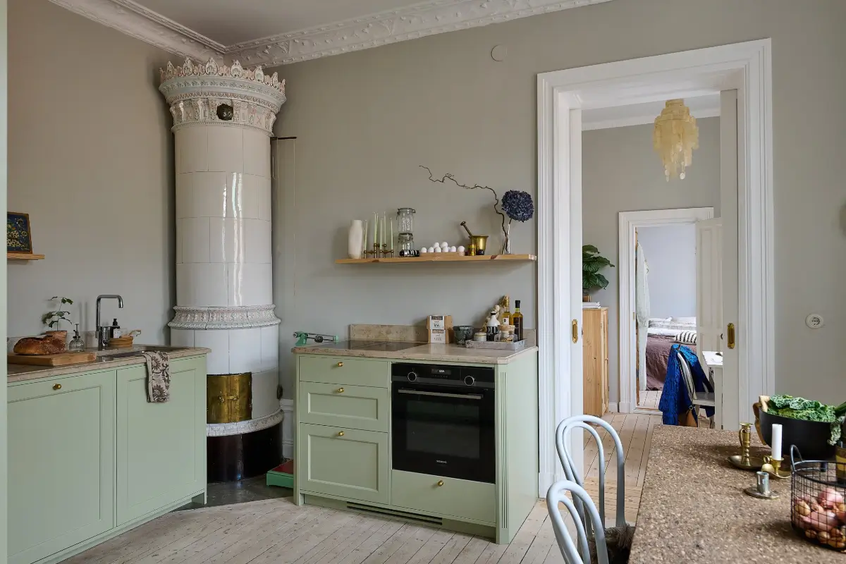 A Classic Stockholm Family Apartment with a Separate Studio 10 kitchen green cabinets fireplace