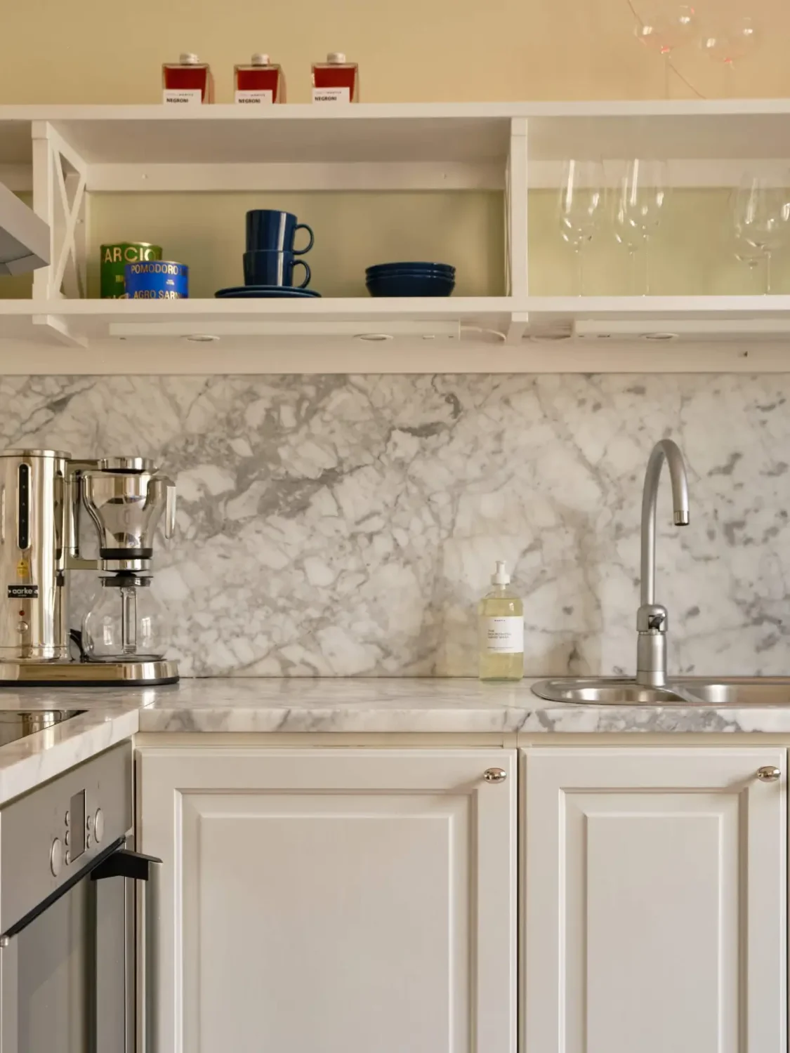 Pastel Hues in a Light-Filled 1880s Apartment in Stockholm 20 kitchen open cabinets marble countertop backsplash nordroom
