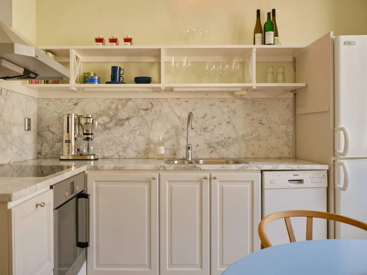 Pastel Hues in a Light-Filled 1880s Apartment in Stockholm 21 kitchen open storage marble countertop