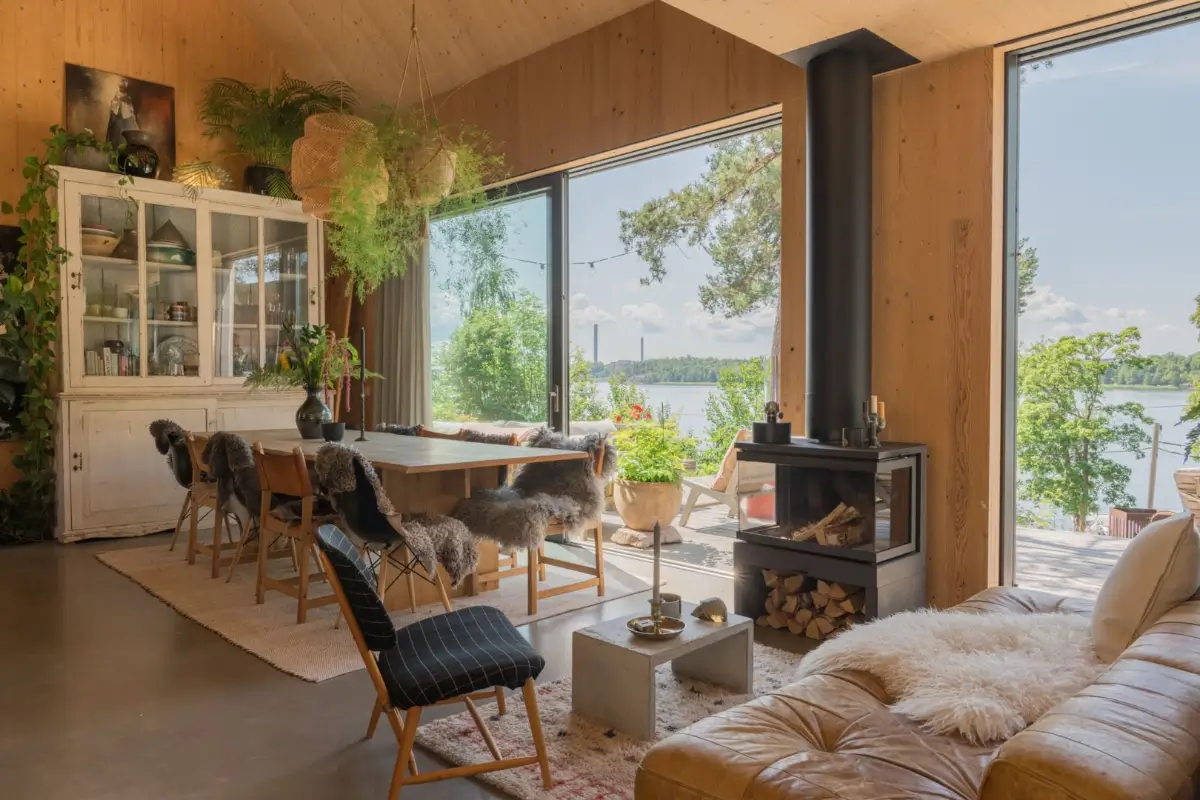 A Modern Wooden Cottage with Sea Views Close to Stockholm 1 large wooden dining table wood burner large windows sea views