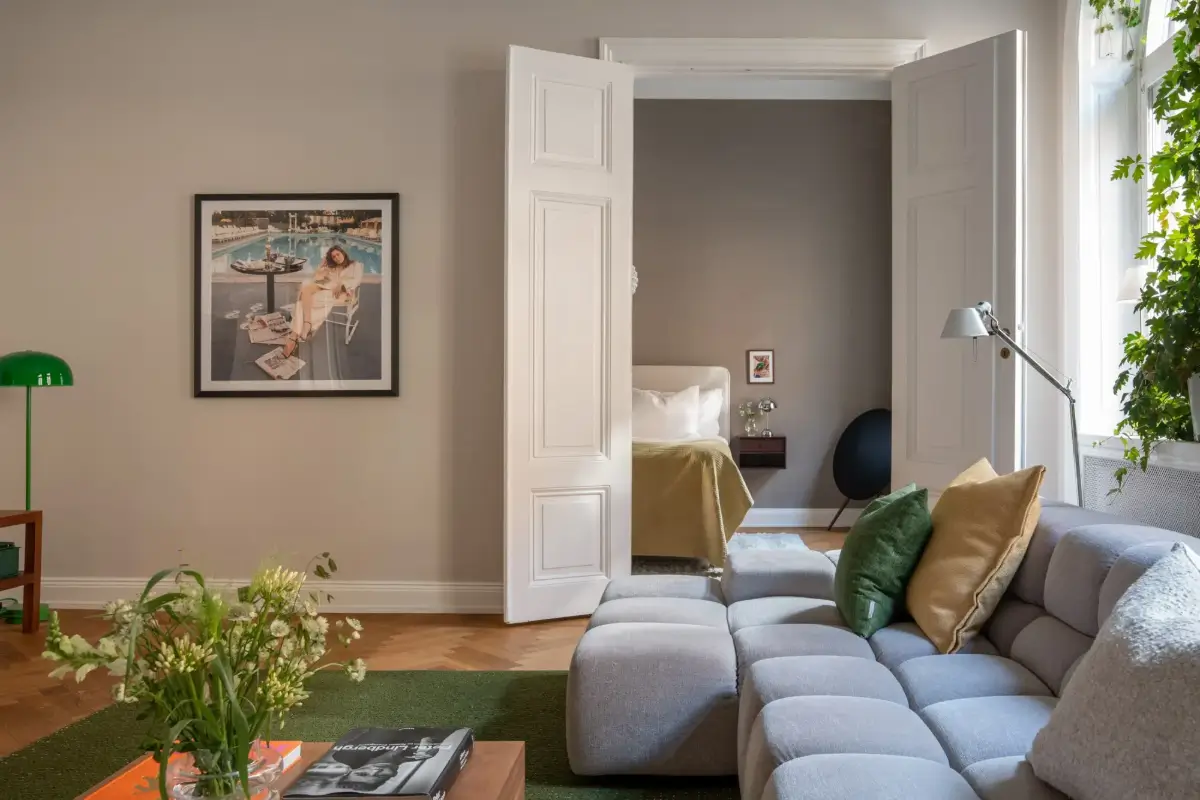 Arched Windows and Design Classics in a 19th Century Apartment 4 living room double doors to bedroom