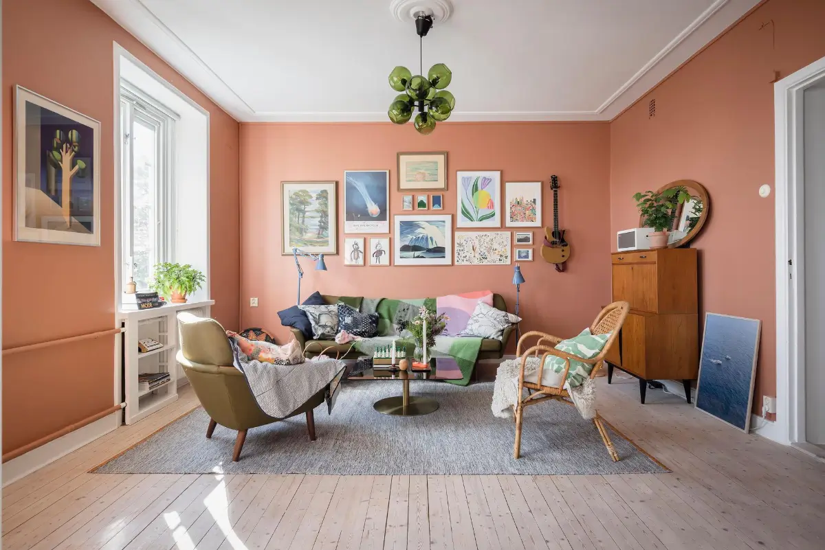 A Colorful 1920s Family Apartment in Sweden 3 living room gallery wall green sofa nordroom