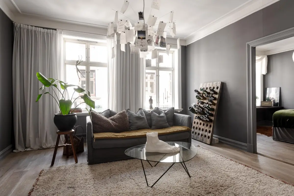 A Dark Gray Swedish Apartment with an Olive Green Kitchen 10 living room gray walls large windows