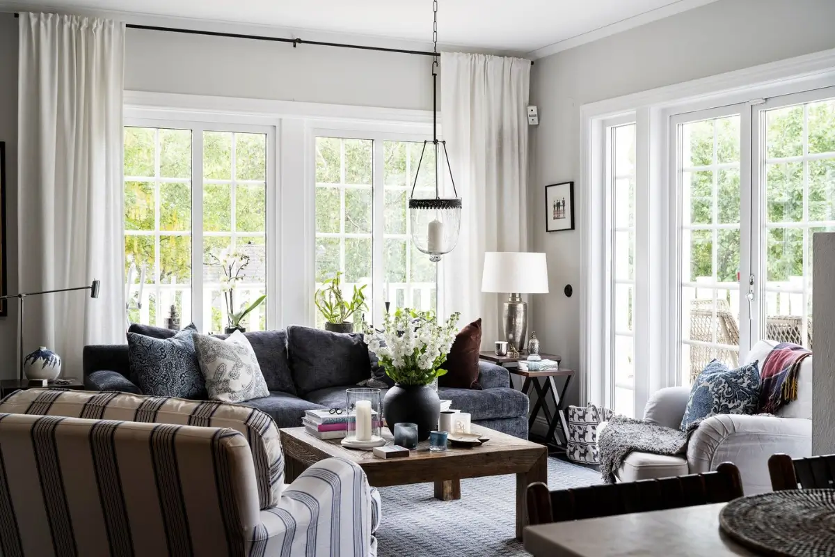 Scandinavian Design Meets The Hamptons in a Swedish Country House 10 living room large windows garden access nordroom