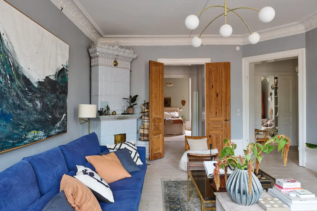 A Classic Stockholm Family Apartment with a Separate Studio 2 living room pastel blue fireplace double wooden doors