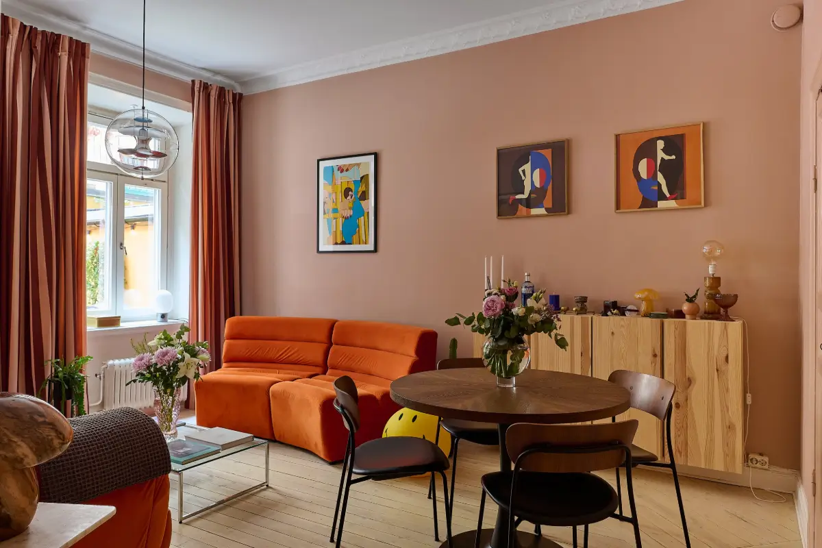 A Colorful Stockholm Apartment with a Large Terrace 1 living room pink walls orange sofa
