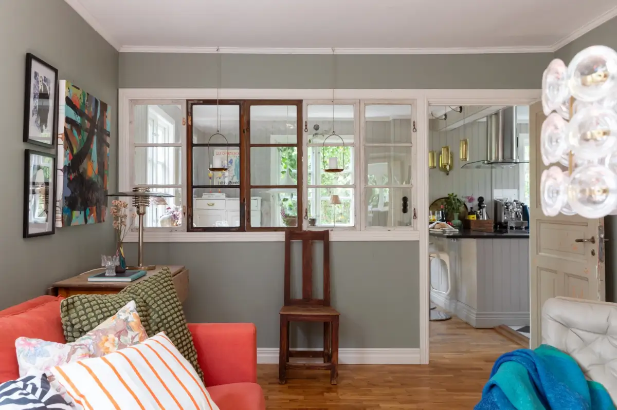 A Renovated 1920s Villa with a Spectacular Garden 11 living room reclaimed windows in wall