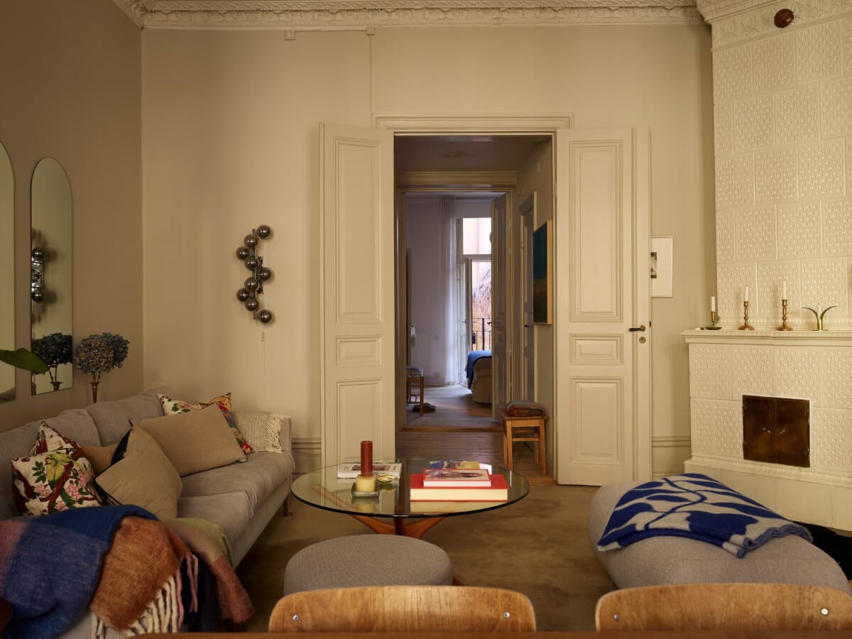 Blue and Red Color Accents in a Stylish Scandinavian Apartment 3 living room stucco fireplace double doors