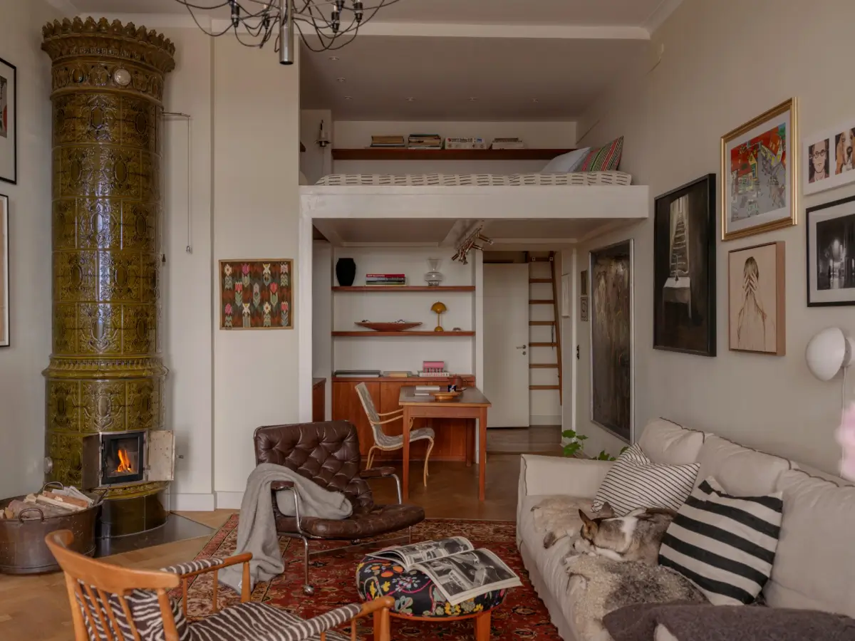 A Classic Late 19th Century Apartment with Magnificent Views of Stockholm 14 living room with fireplace and loft area