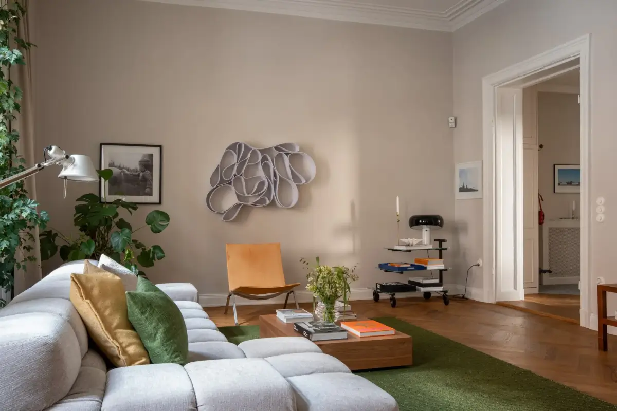 Arched Windows and Design Classics in a 19th Century Apartment 5 living roomg gray walls green rug