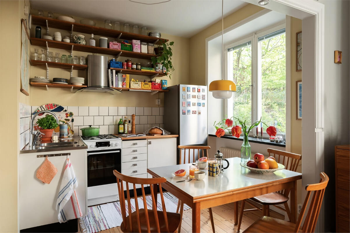 Best of 2025: Studio & Loft Apartments 2 midcentury-swedish-kitchen-beige-walls-formica-table-wooden-shelves-nordroom
