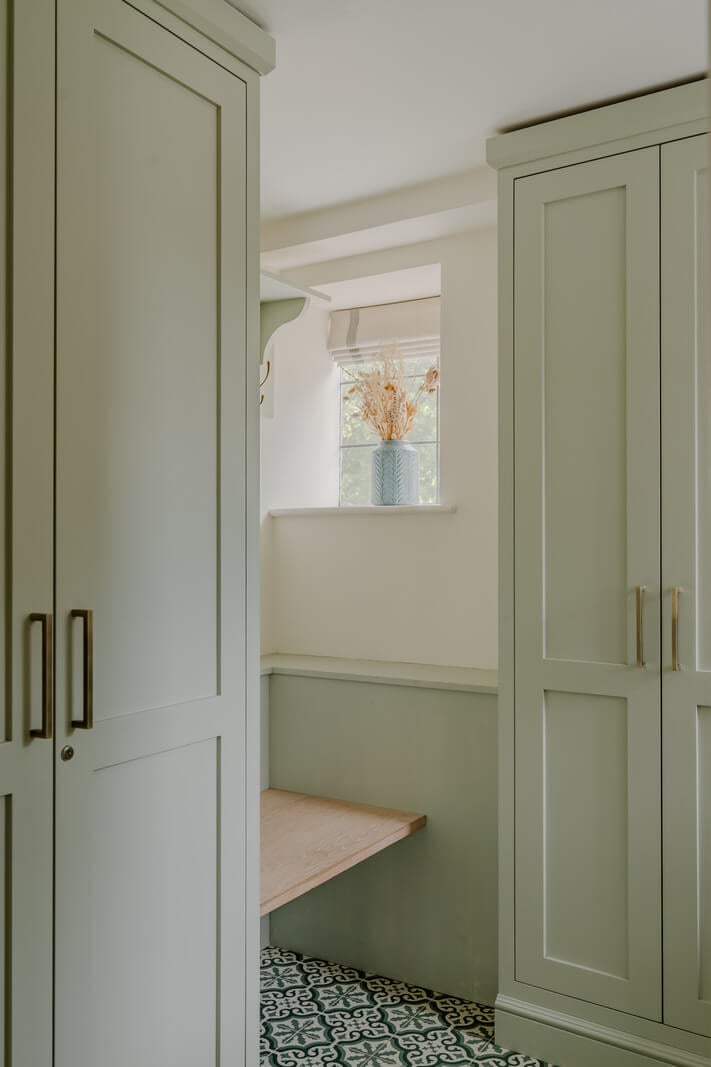 A Stone English Cottage with a Blue and Pink Kitchen 5 mint green utility room