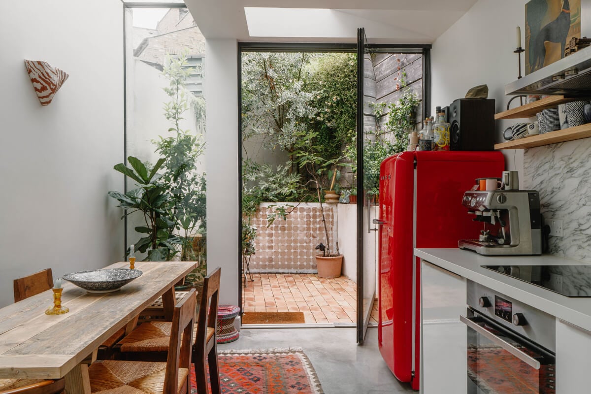 A Modern Ground-Floor Apartment with a Tiny Patio Garden 4 modern extended kitchen patio garden red smeg fridge