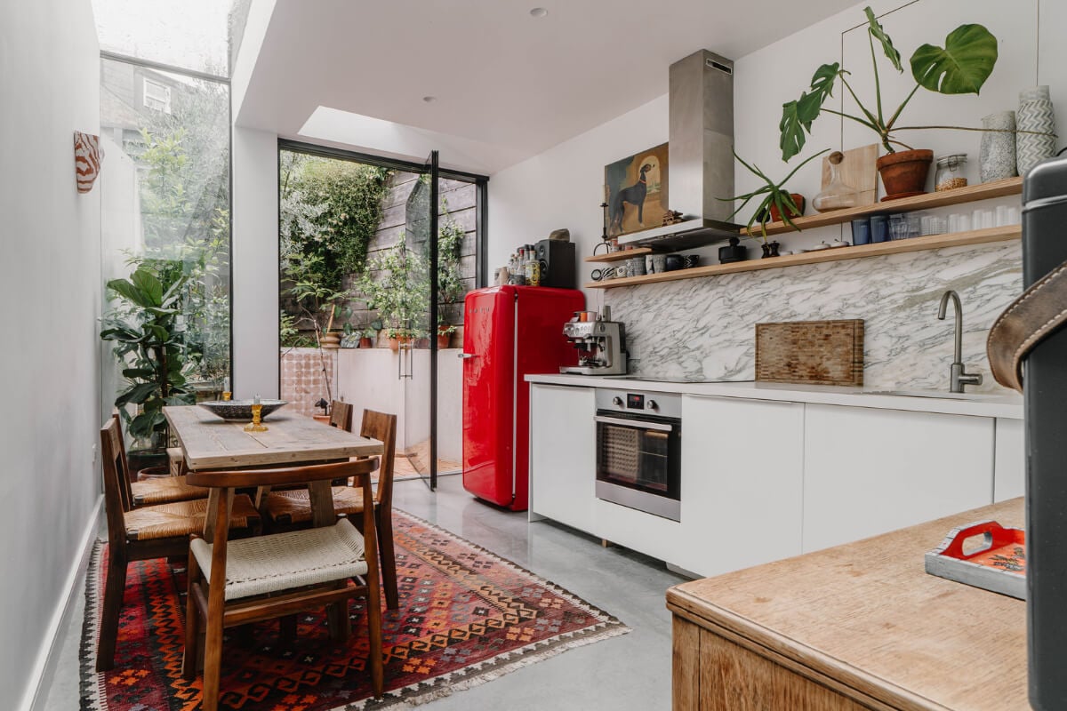 A Modern Ground-Floor Apartment with a Tiny Patio Garden 1 modern extended kitchen skylight white cabinets