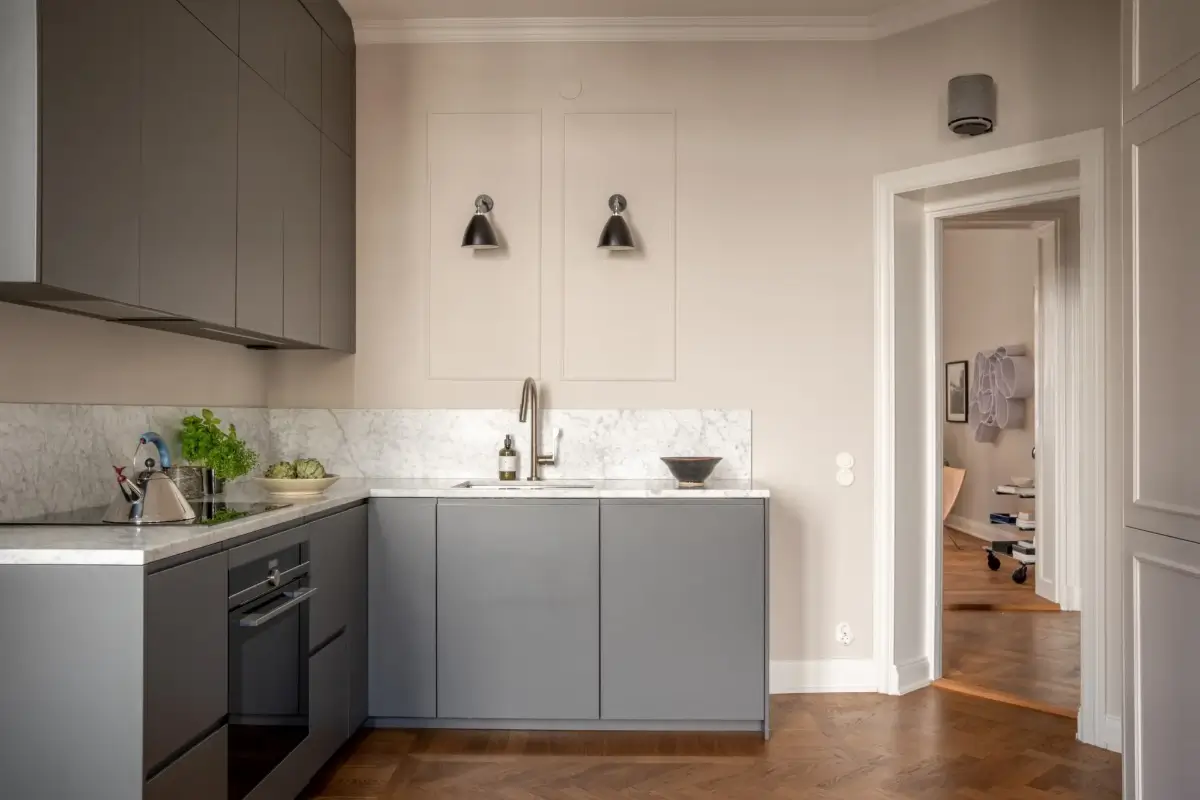 Arched Windows and Design Classics in a 19th Century Apartment 10 modern gray kitchen marble countertop