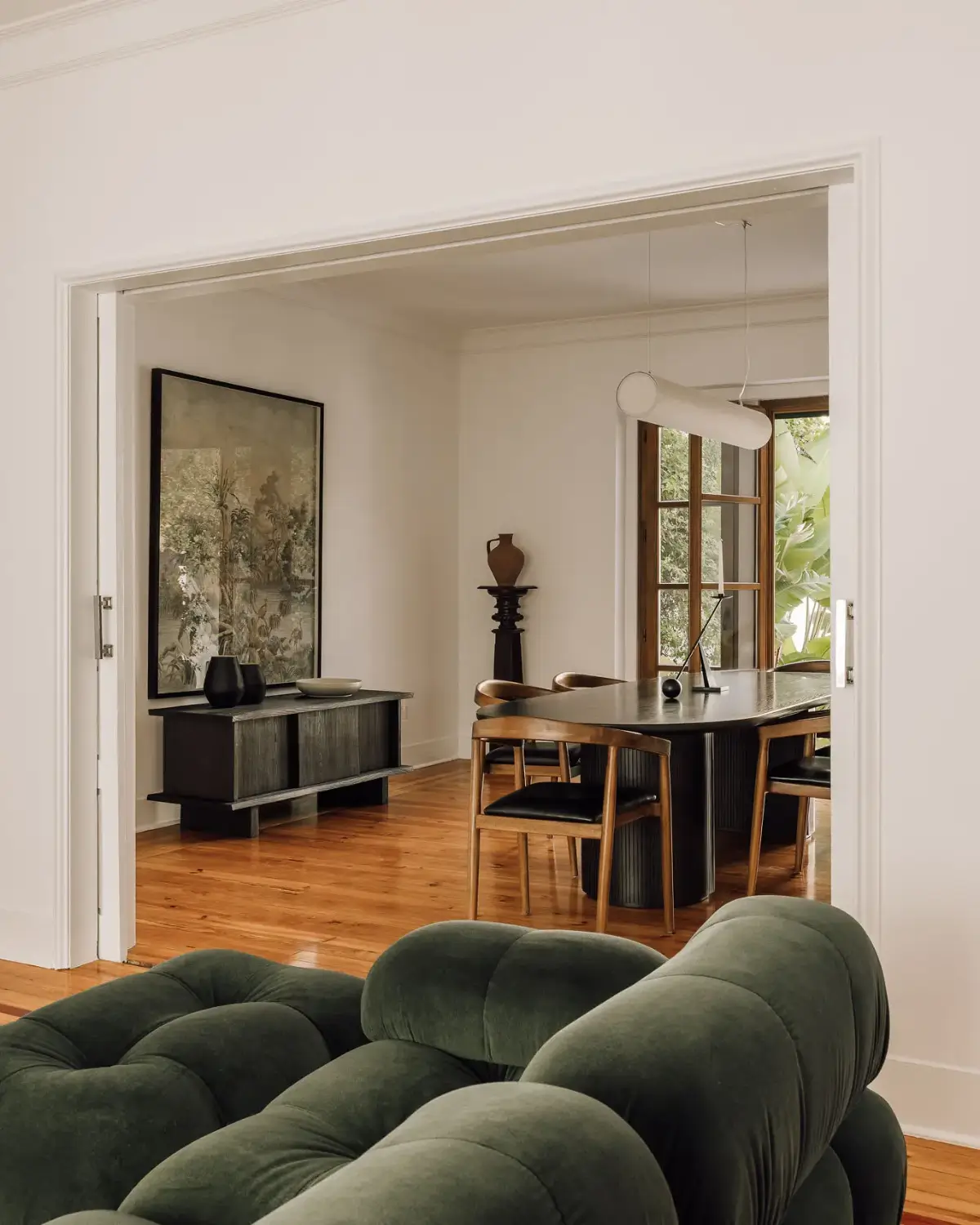 An Art Deco Villa with a Moroccan-Inspired Garden in Portugal 3 open-plan living space green sofa dining room