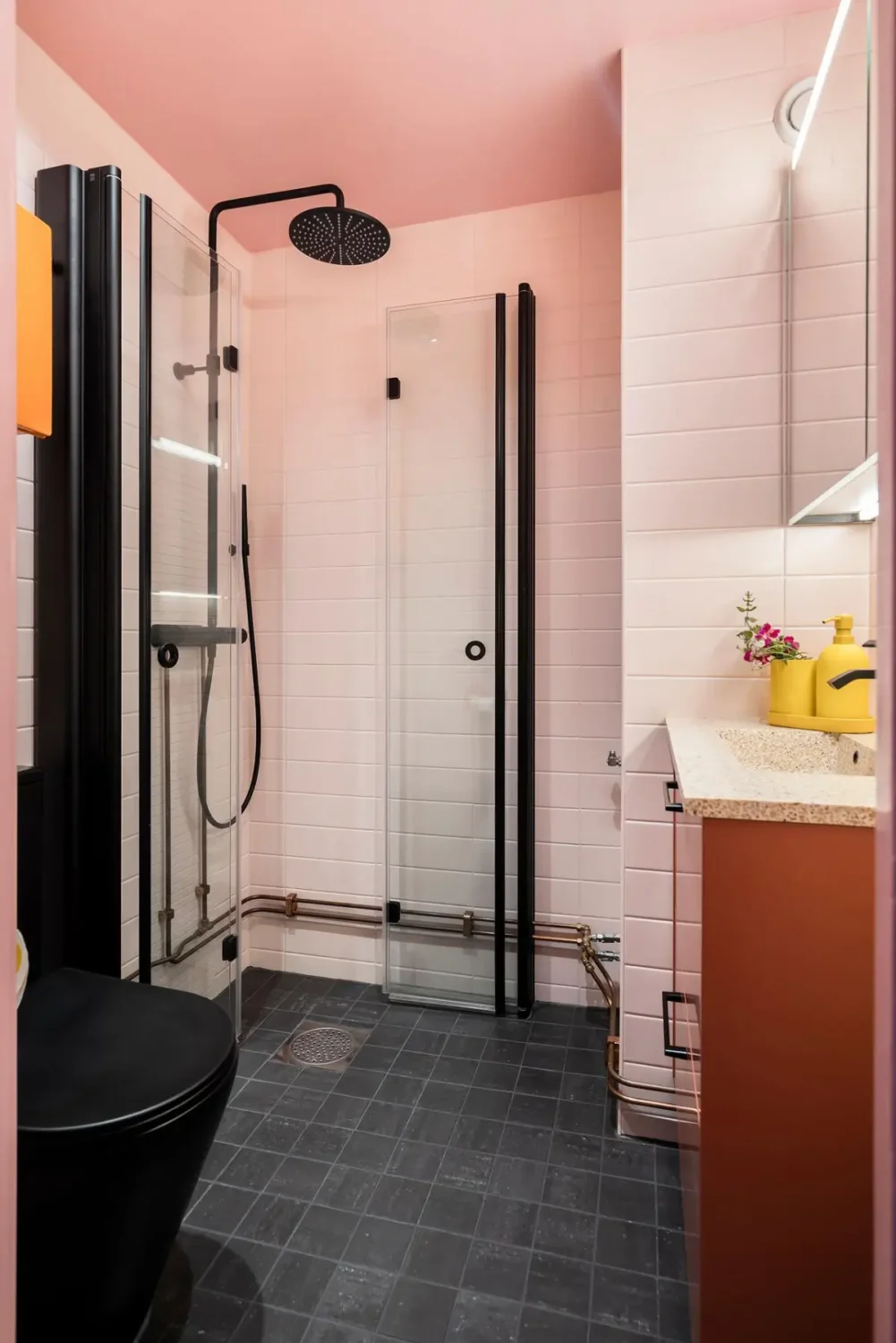 A Colorful 1920s Family Apartment in Sweden 33 pink bathroom black fittings