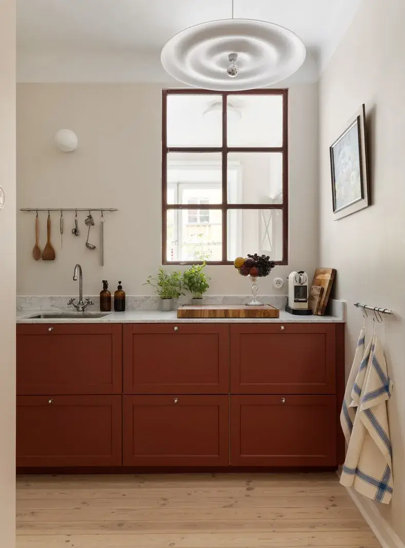 A Red Kitchen in a Small and Light Scandinavian Apartment 4 red kitchen inner window