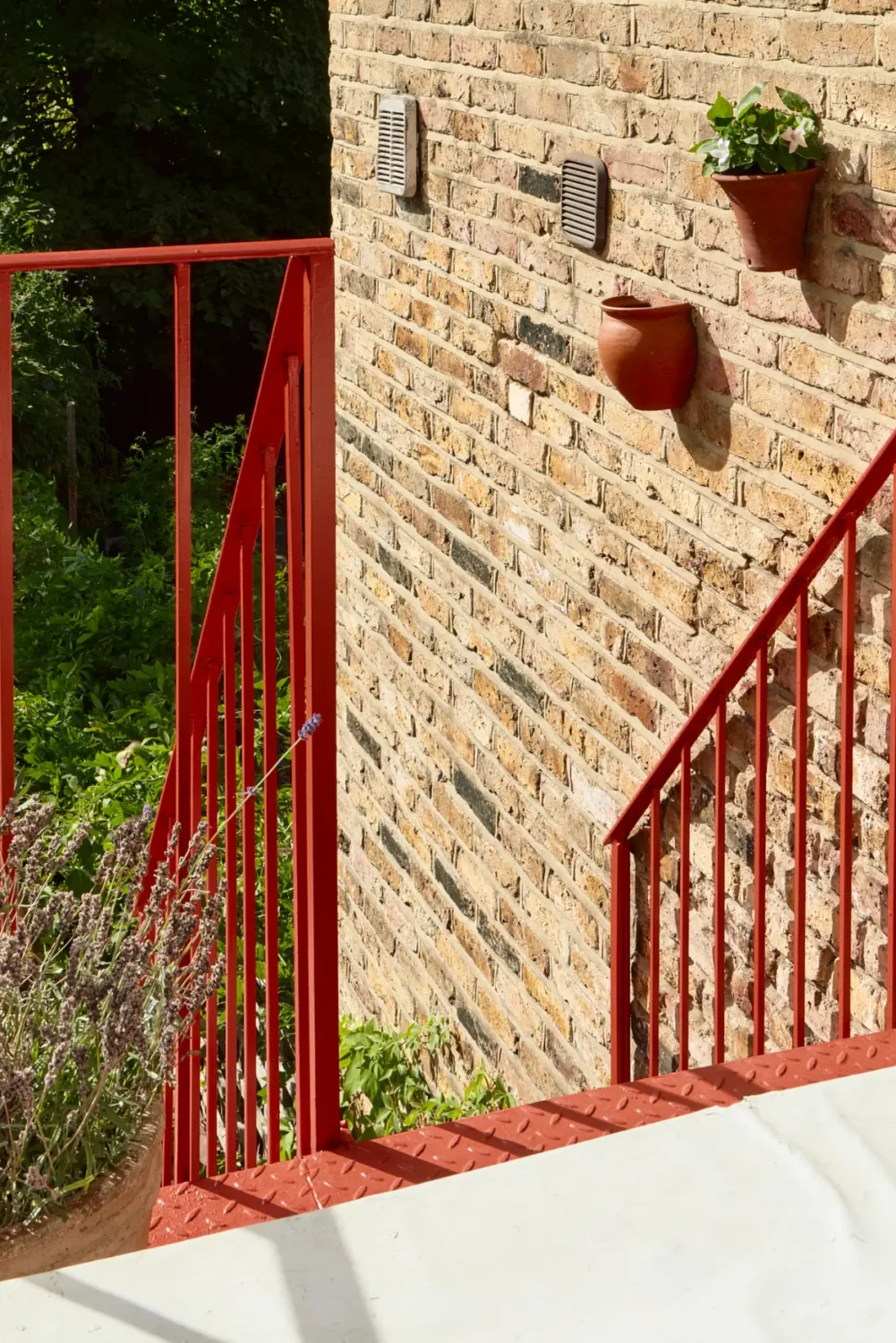 A Classic Victorian Duplex with a Lush, Private Garden in London 31 red steel stairs to garden