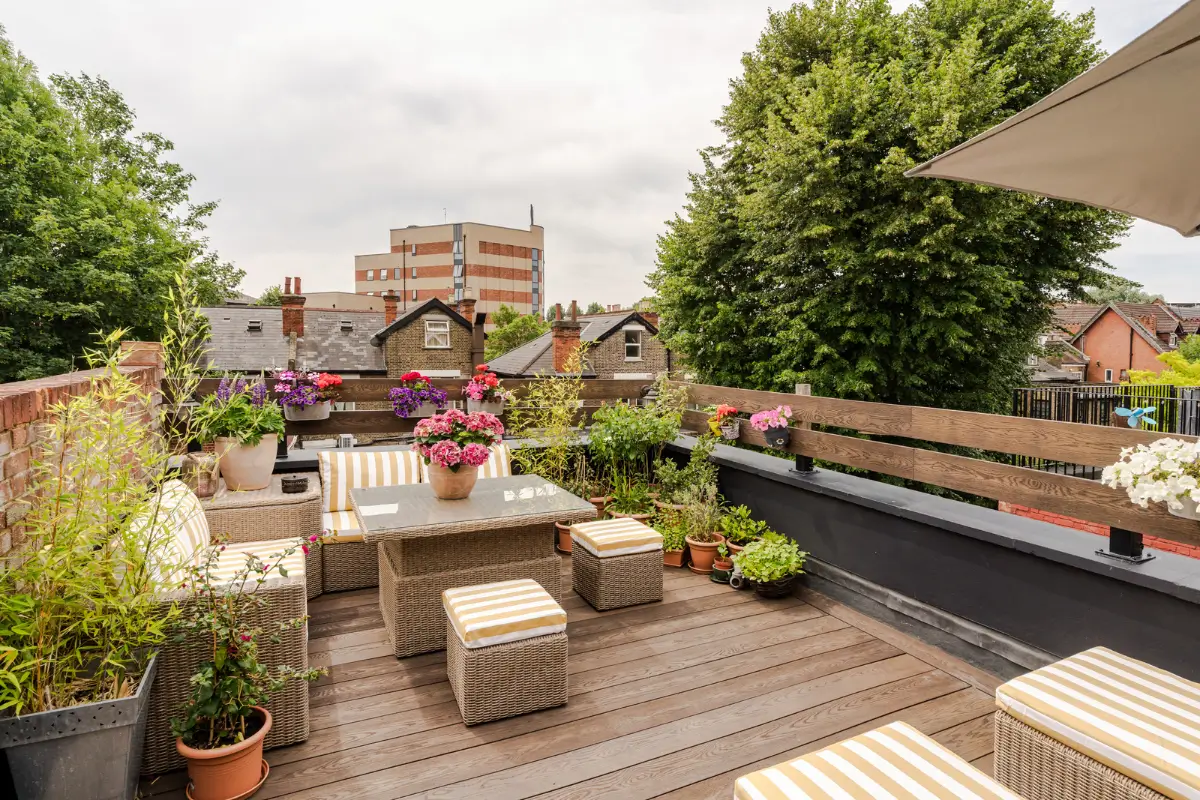 A Three-Bedroom Duplex Apartment with a Large Roof Terrace in London 22 roof terrace yellow striped cushions