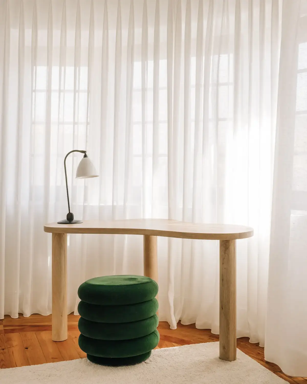 An Art Deco Villa with a Moroccan-Inspired Garden in Portugal 11 rounded desk green pouf