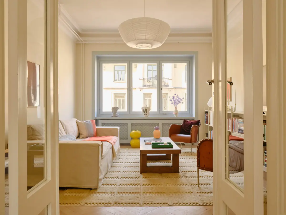 Pastel Hues in a Light-Filled 1880s Apartment in Stockholm 7 scandi living room beige-yellow walls blue window frames nordroom