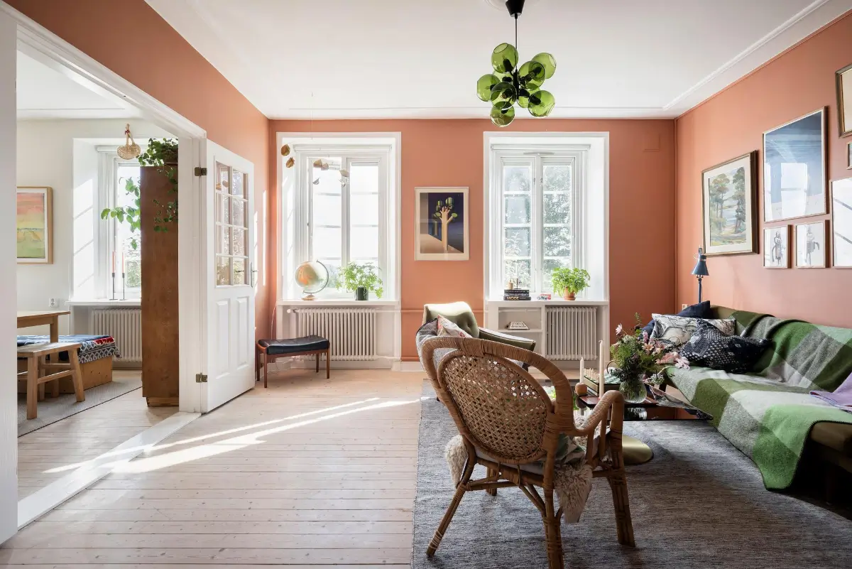 A Colorful 1920s Family Apartment in Sweden 2 scandi living room wooden floor terracotta walls nordroom
