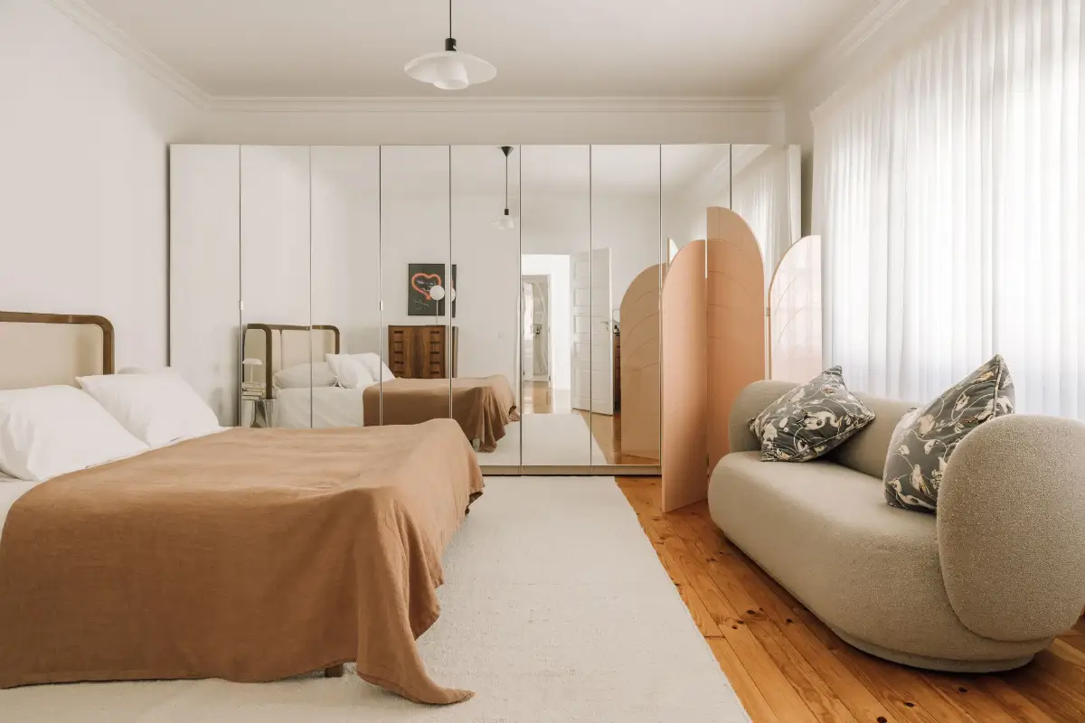 An Art Deco Villa with a Moroccan-Inspired Garden in Portugal 9 serene bedroom wooden floor wall of wardrobes with mirror doors nordroom