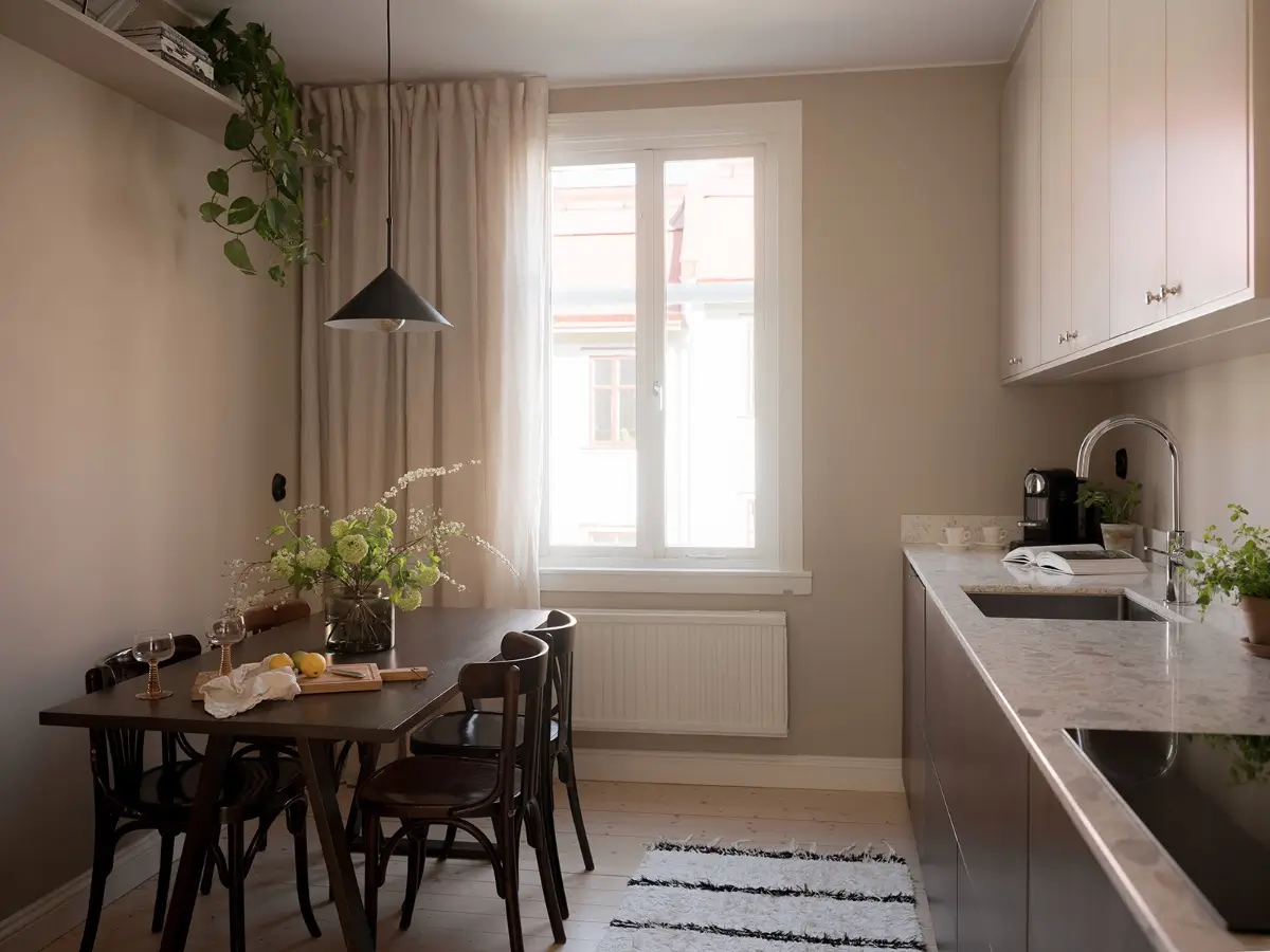 Neutral Shades and Period Elements in a Scandi Apartment 19 serene kitchen wooden dining table high bookshelf