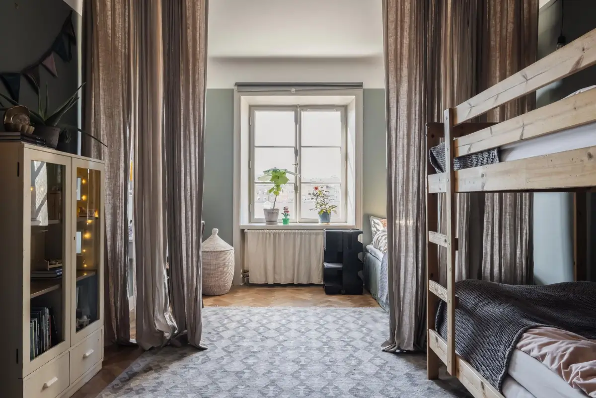Colorful Rooms in a Practical Stockholm Family Apartment 15 shared kids bedroom curtain room divider