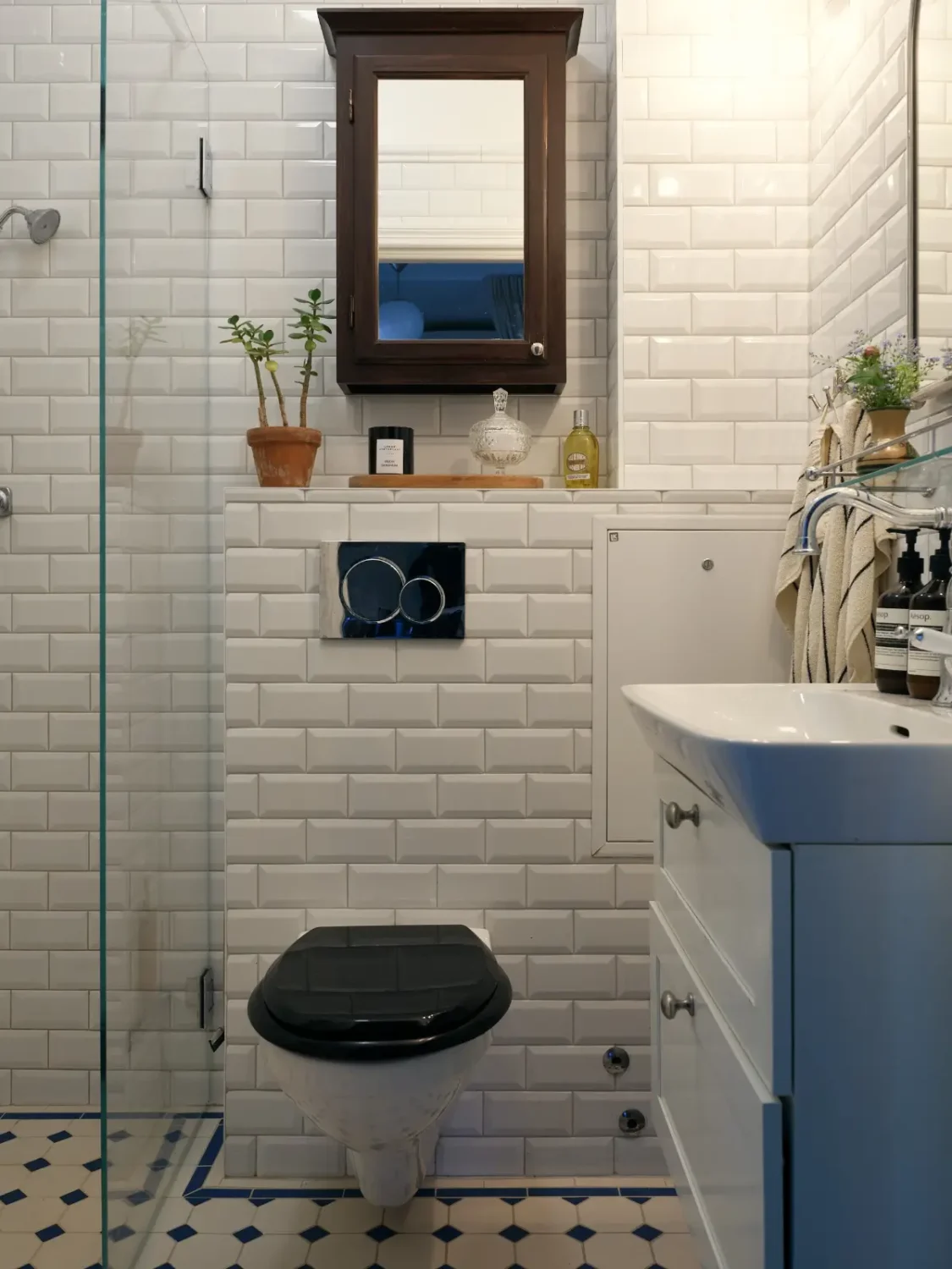 A Muted Color Palette in a Cozy 1920s Apartment in Stockholm 19 small classic bathroom victorian-style tilework nordroom