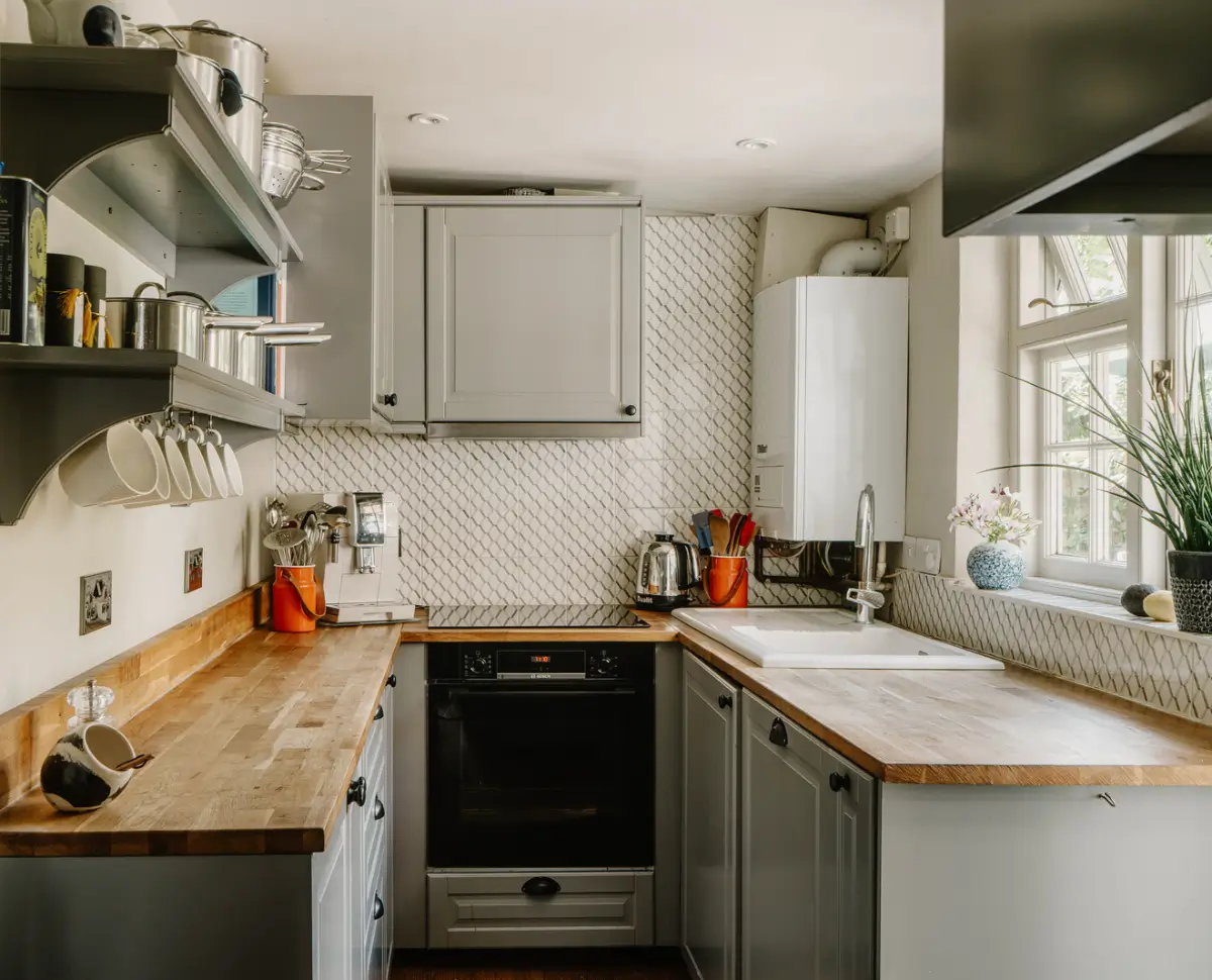 A 17th-Century Home with Original Elements in an English Seaside Town 7 small gray u-shaped kitchen
