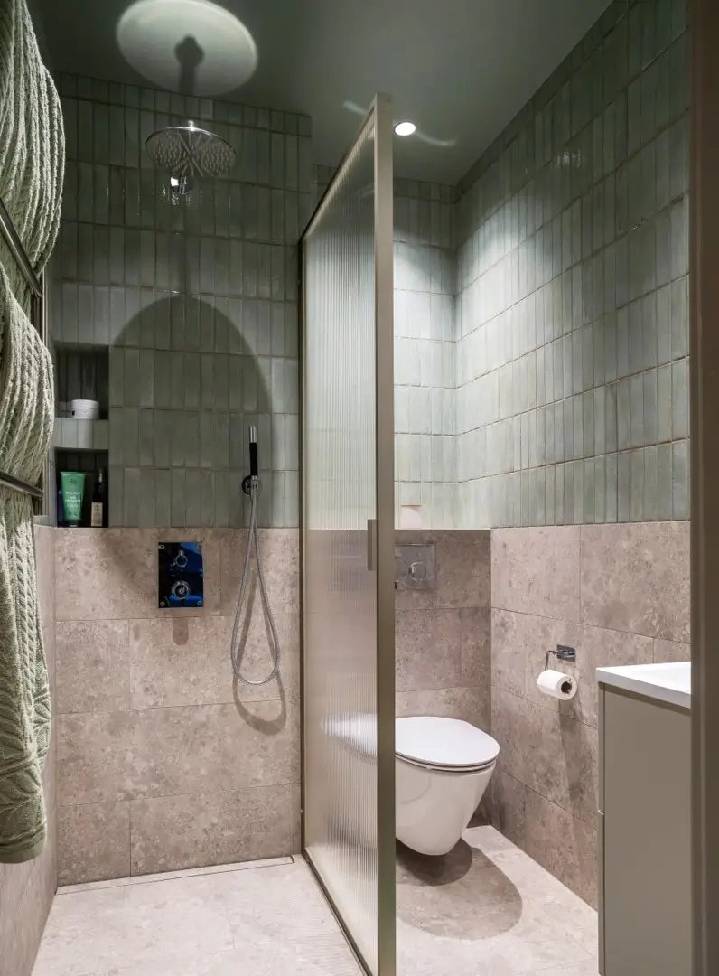 A Harmonious Color Palette in a Luxurious Stockholm Duplex Apartment 18 small hotel-style bathroom blue tiles