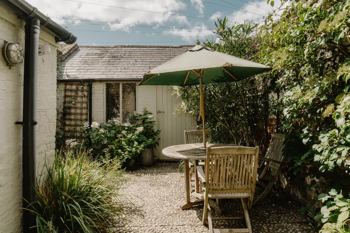 A 17th-Century Home with Original Elements in an English Seaside Town 21 small walled garden with dining table