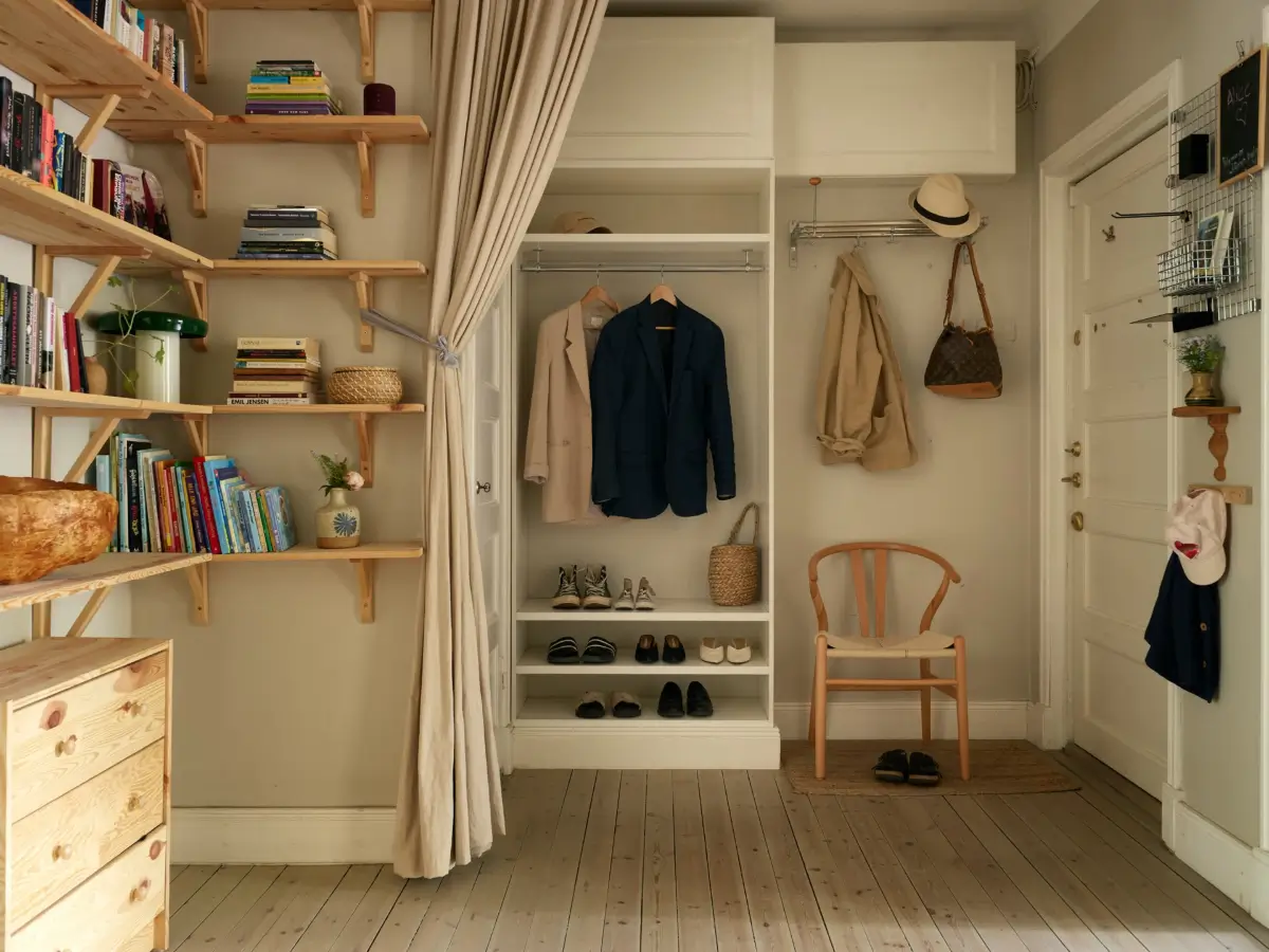 A Muted Color Palette in a Cozy 1920s Apartment in Stockholm 23 spacious hall with shelves cabinets and small storage nordroom