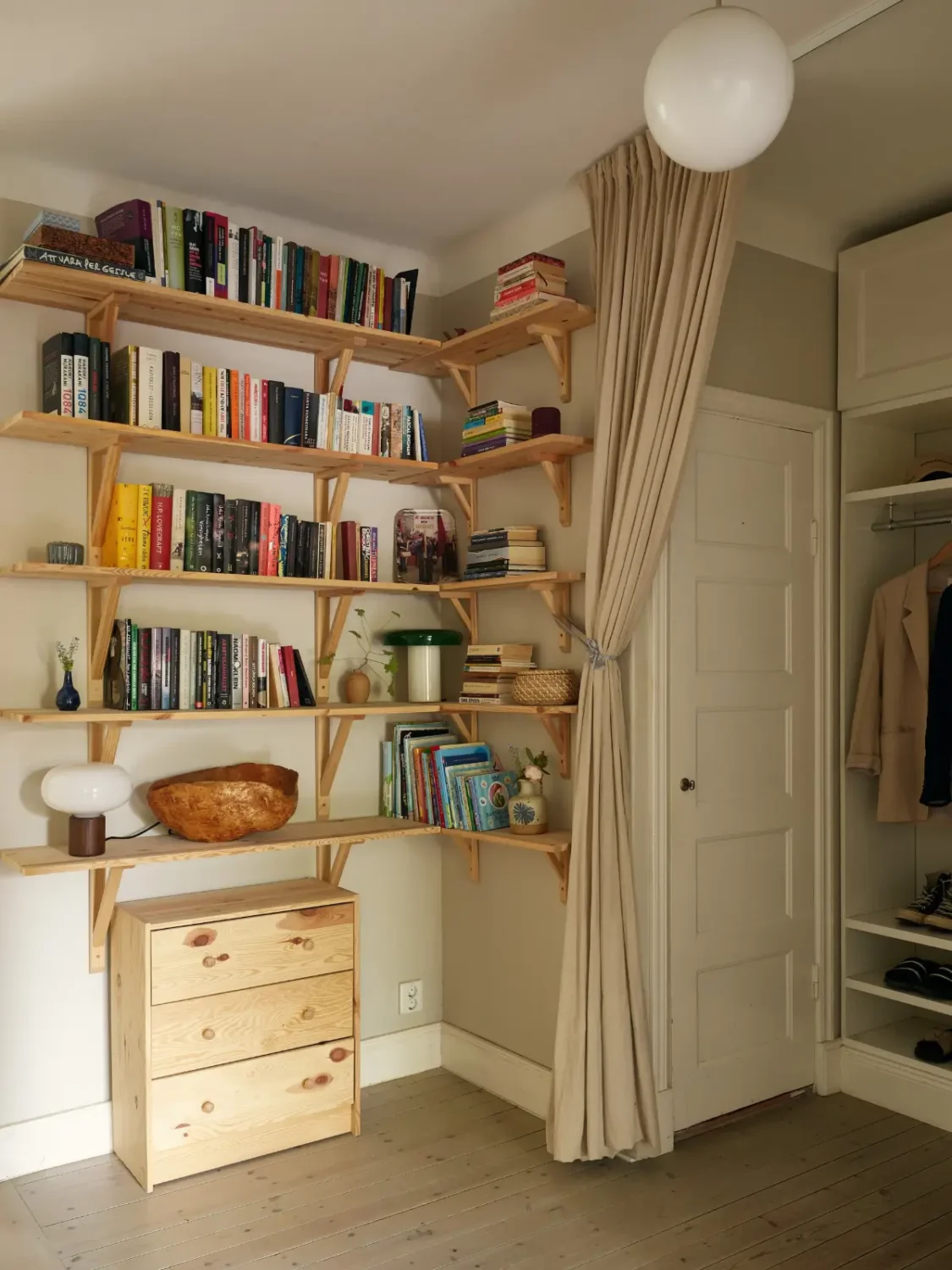 A Muted Color Palette in a Cozy 1920s Apartment in Stockholm 22 spacious hall with wooden shelves nordroom