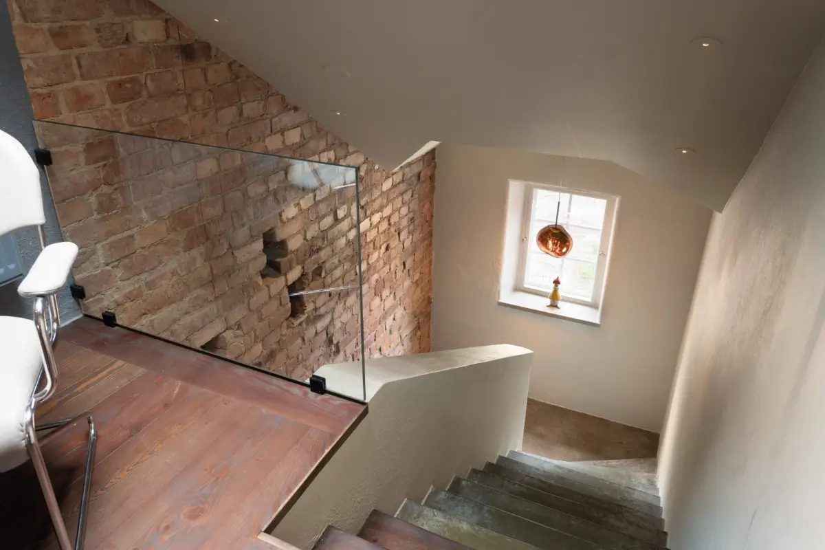 A Harmonious Color Palette in a Luxurious Stockholm Duplex Apartment 21 staircase exposed brick wall