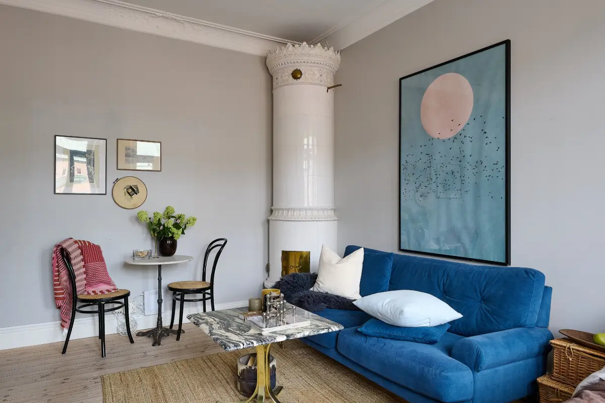 A Classic Stockholm Family Apartment with a Separate Studio 38 studio with blue sofa and fireplace